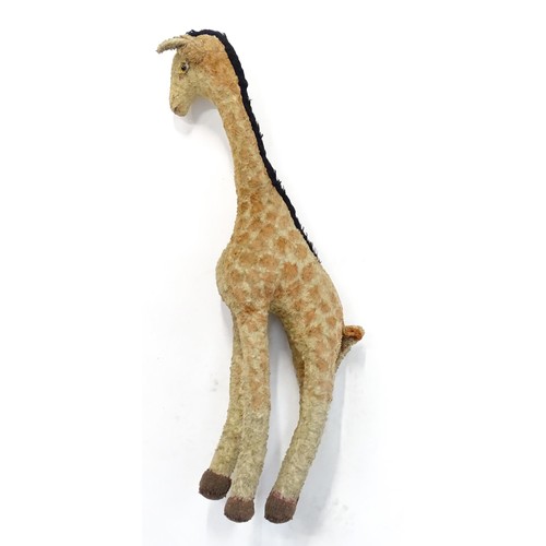 1291 - Toy: A large 20thC straw filled giraffe with glass eyes. Approx. 36 1/2