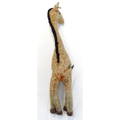 1291 - Toy: A large 20thC straw filled giraffe with glass eyes. Approx. 36 1/2