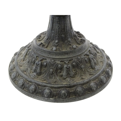 357 - A 20thC cast vase of goblet form decorated in relief with Bacchanalian putti. Approx. 9 3/4
