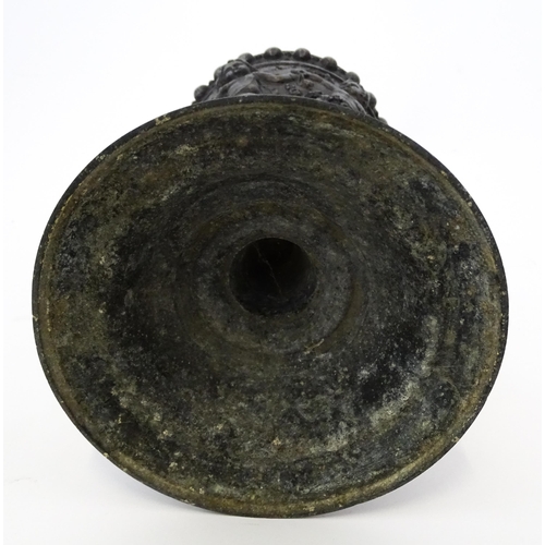 357 - A 20thC cast vase of goblet form decorated in relief with Bacchanalian putti. Approx. 9 3/4