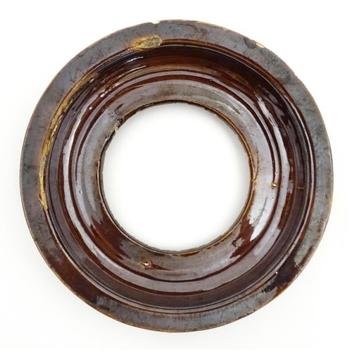 148 - A 19thC Measham bargeware teapot on stand decorated with flowers and foliage. Approx. 9 1/4