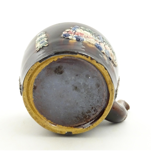 148 - A 19thC Measham bargeware teapot on stand decorated with flowers and foliage. Approx. 9 1/4