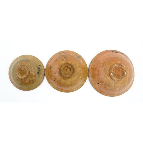 159 - Three graduated terracotta dishes decorated with stylised foliate detail. Largest approx. 12 3/4