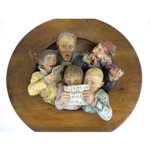 162 - A large Austrian terracotta relief plaque depicting a choir and musicians, with circular wooden moun... 