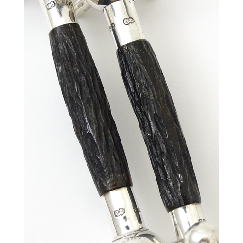 434 - A pair of silver knife rests with antler detail, hallmarked Sheffield 1913, maker John Biggin. Appro... 