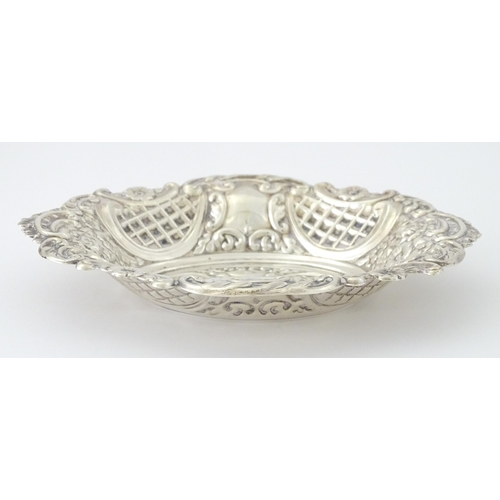 438 - A silver bon bon dish with embossed decoration, hallmarked London 1957, maker Taite & Sons. Approx. ... 