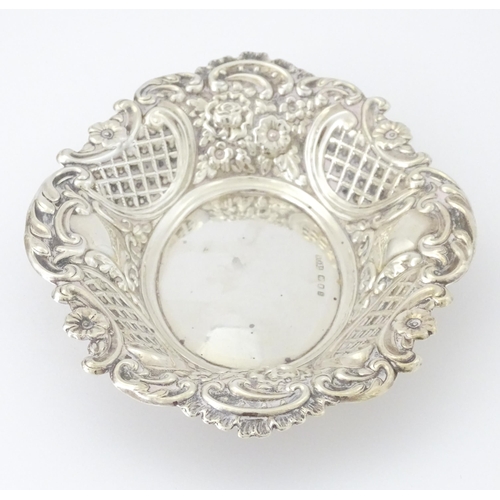 438 - A silver bon bon dish with embossed decoration, hallmarked London 1957, maker Taite & Sons. Approx. ... 