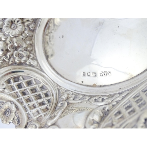 438 - A silver bon bon dish with embossed decoration, hallmarked London 1957, maker Taite & Sons. Approx. ... 