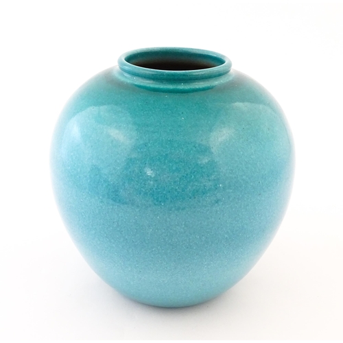 168 - A Continental vase of bulbous form with blue / turquoise glaze. Marked Serra under. Approx. 9 1/4