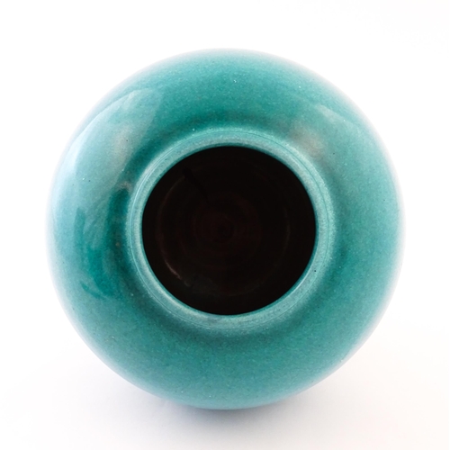 168 - A Continental vase of bulbous form with blue / turquoise glaze. Marked Serra under. Approx. 9 1/4
