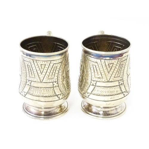 483 - A pair of Columbian .900 silver tankards with engraved decoration. Approx. 5 1/2