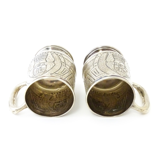 483 - A pair of Columbian .900 silver tankards with engraved decoration. Approx. 5 1/2