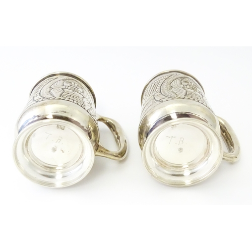 483 - A pair of Columbian .900 silver tankards with engraved decoration. Approx. 5 1/2