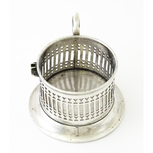 394 - A silver cup holder / sleeve with pierced detail, hallmarked Chester 1913, maker Simpson & Benzie. A... 