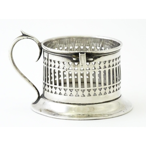 394 - A silver cup holder / sleeve with pierced detail, hallmarked Chester 1913, maker Simpson & Benzie. A... 
