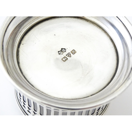 394 - A silver cup holder / sleeve with pierced detail, hallmarked Chester 1913, maker Simpson & Benzie. A... 