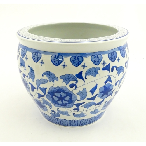 153 - An Oriental blue and white planter with floral and foliate decoration. Approx. 10
