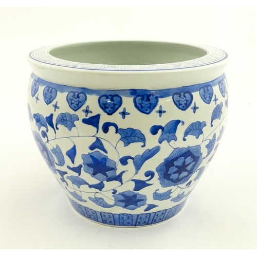 153 - An Oriental blue and white planter with floral and foliate decoration. Approx. 10
