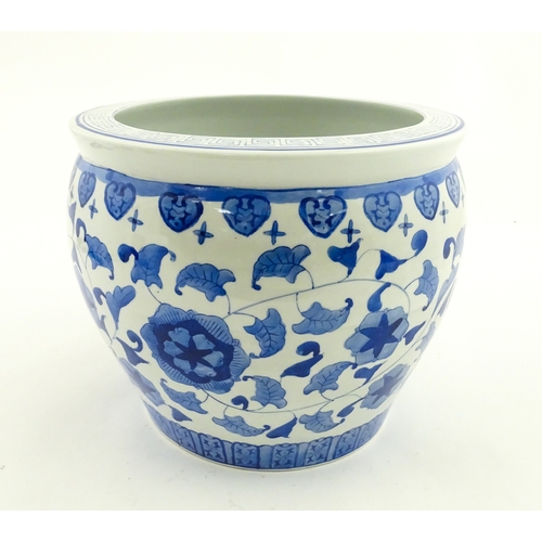 153 - An Oriental blue and white planter with floral and foliate decoration. Approx. 10