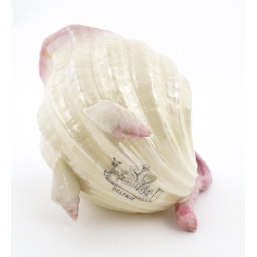 80 - A Belleek milk jug in the Neptune pattern with shell detail. Marked under. Approx. 3