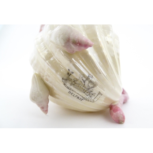 80 - A Belleek milk jug in the Neptune pattern with shell detail. Marked under. Approx. 3