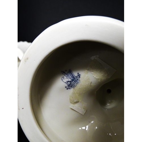 82 - A pair of Belleek figures comprising Girl Basket Carrier and Boy Basket Carrier. Marked under. Appro... 