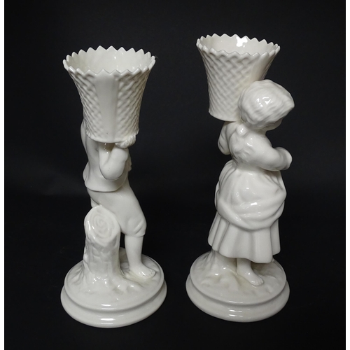 82 - A pair of Belleek figures comprising Girl Basket Carrier and Boy Basket Carrier. Marked under. Appro... 