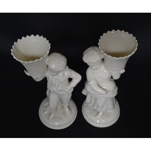 82 - A pair of Belleek figures comprising Girl Basket Carrier and Boy Basket Carrier. Marked under. Appro... 