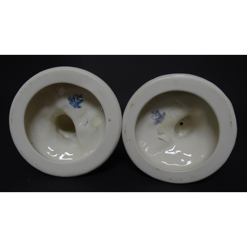 82 - A pair of Belleek figures comprising Girl Basket Carrier and Boy Basket Carrier. Marked under. Appro... 