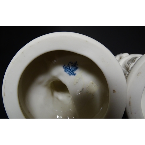 82 - A pair of Belleek figures comprising Girl Basket Carrier and Boy Basket Carrier. Marked under. Appro... 