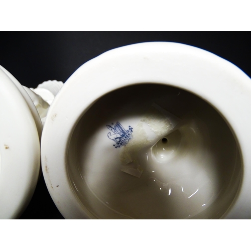 82 - A pair of Belleek figures comprising Girl Basket Carrier and Boy Basket Carrier. Marked under. Appro... 