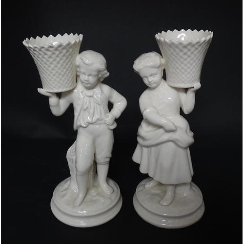 82 - A pair of Belleek figures comprising Girl Basket Carrier and Boy Basket Carrier. Marked under. Appro... 
