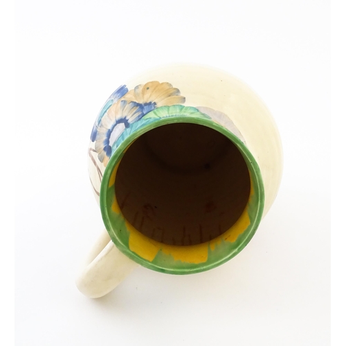 85 - A Clarice Cliff lotus jug / vase with single handle decorated in the Aurea pattern. Marked under 'Ha... 