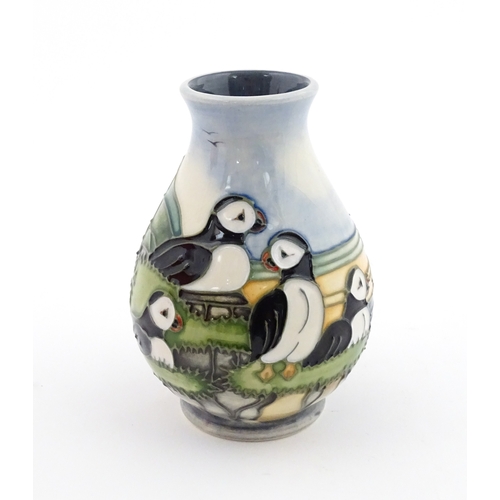 100 - A Moorcroft vase decorated in the Puffin pattern. Marked under. With box. Approx. 5 1/4