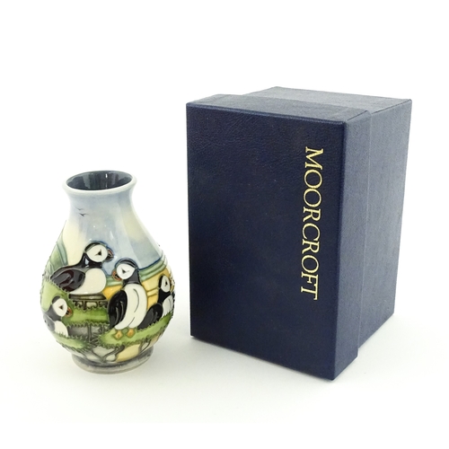100 - A Moorcroft vase decorated in the Puffin pattern. Marked under. With box. Approx. 5 1/4