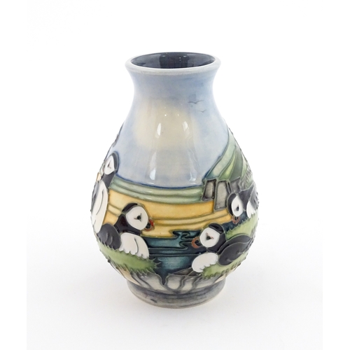 100 - A Moorcroft vase decorated in the Puffin pattern. Marked under. With box. Approx. 5 1/4