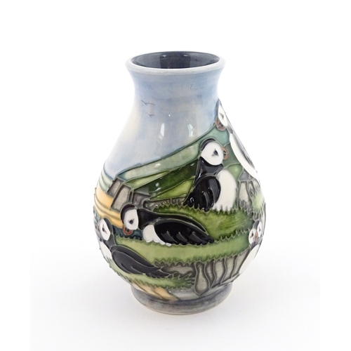 100 - A Moorcroft vase decorated in the Puffin pattern. Marked under. With box. Approx. 5 1/4