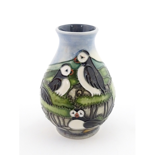 100 - A Moorcroft vase decorated in the Puffin pattern. Marked under. With box. Approx. 5 1/4