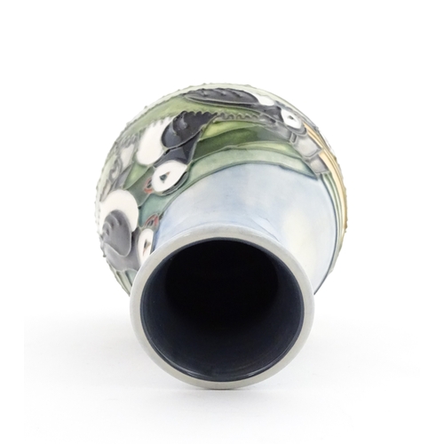 100 - A Moorcroft vase decorated in the Puffin pattern. Marked under. With box. Approx. 5 1/4