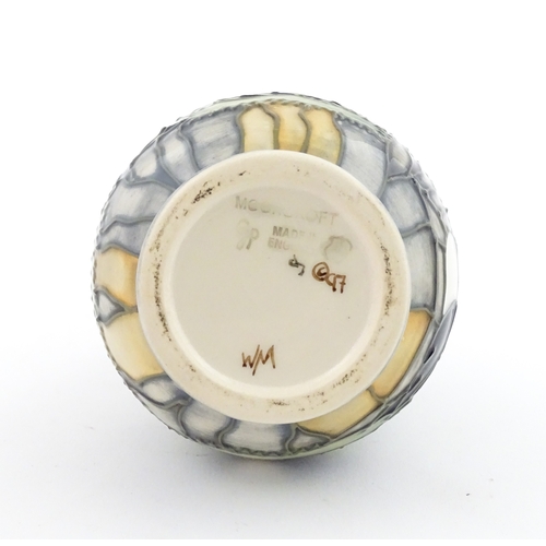 100 - A Moorcroft vase decorated in the Puffin pattern. Marked under. With box. Approx. 5 1/4