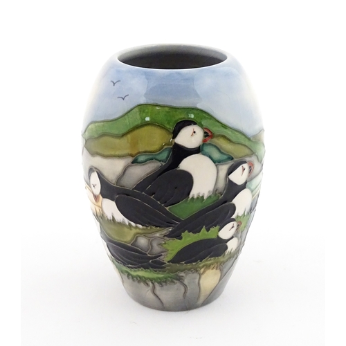 101 - A Moorcroft vase decorated in the Puffin pattern. Marked under. With box. Approx. 5 1/4