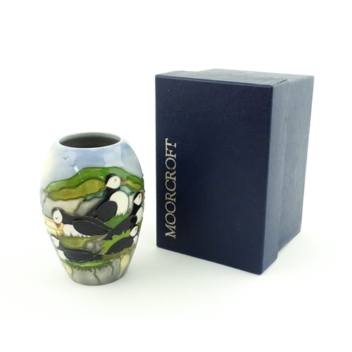 101 - A Moorcroft vase decorated in the Puffin pattern. Marked under. With box. Approx. 5 1/4