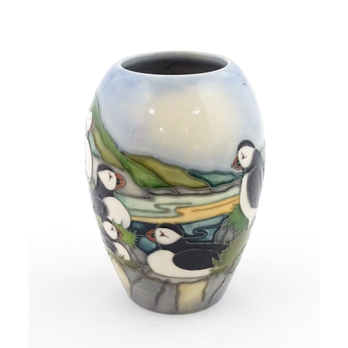 101 - A Moorcroft vase decorated in the Puffin pattern. Marked under. With box. Approx. 5 1/4