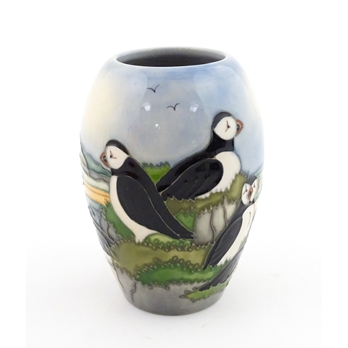 101 - A Moorcroft vase decorated in the Puffin pattern. Marked under. With box. Approx. 5 1/4