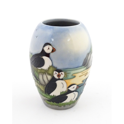101 - A Moorcroft vase decorated in the Puffin pattern. Marked under. With box. Approx. 5 1/4