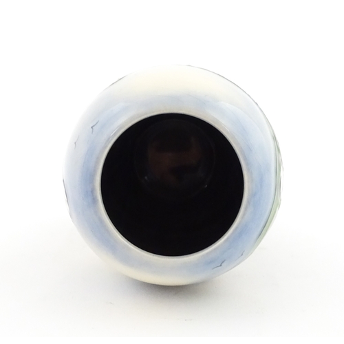 101 - A Moorcroft vase decorated in the Puffin pattern. Marked under. With box. Approx. 5 1/4