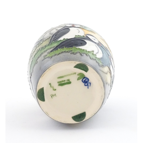 101 - A Moorcroft vase decorated in the Puffin pattern. Marked under. With box. Approx. 5 1/4