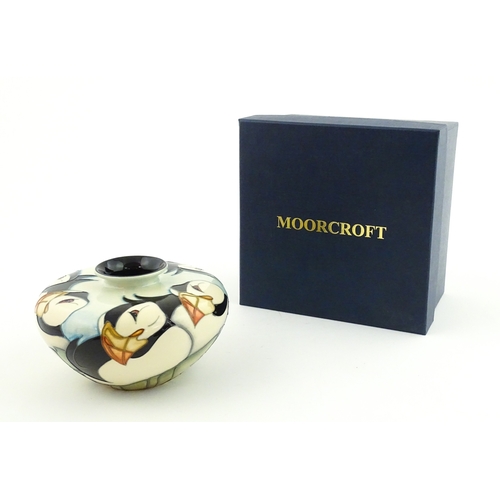 102 - A Moorcroft vase of squat form decorated with puffins. Marked under. With box. Approx. 3 1/2