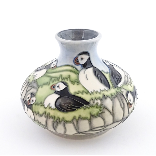 103 - A Moorcroft vase decorated in the Puffin pattern. Marked under. Approx. 4 1/4