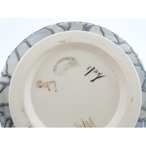 103 - A Moorcroft vase decorated in the Puffin pattern. Marked under. Approx. 4 1/4